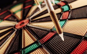 Nahaufnahme einer Dartscheibe mit getroffenen Dartpfeilen